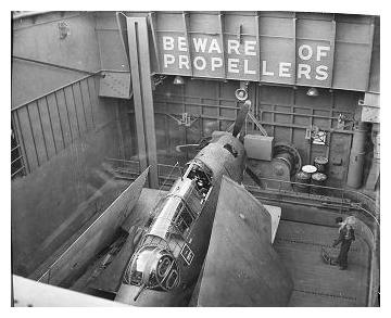 One of 850 squadron Avengers on the forward lielevator about to be raised to flight deck level. Note the man stood on the lift; the controls are visible in the open panel by his feet. February 17th 1944. Photo:   CFB Esquimalt Naval & Military  Museum, VR995.30.11 