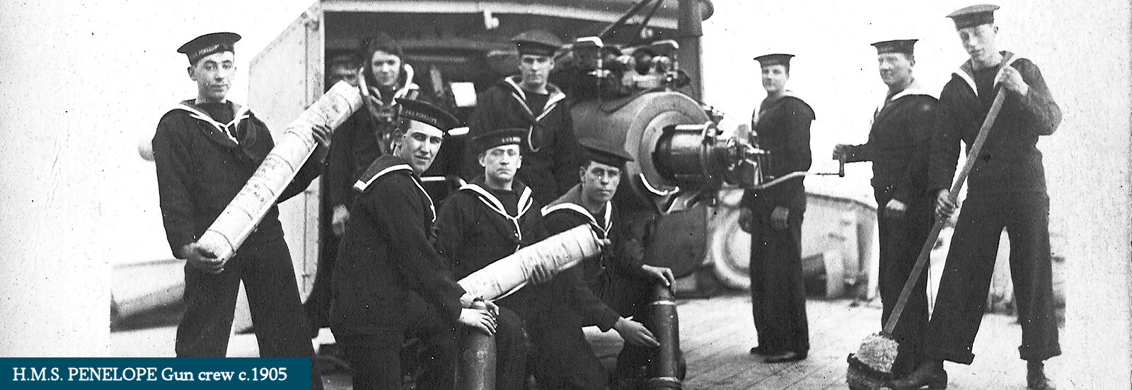 H.M.S. Penelope gun crew posed with shell and charge