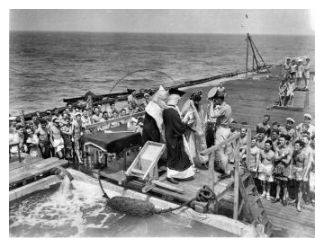 ‘Crossing the Line’ in November 1945; The ‘Pollywogs’ (those who have not crossed the equator before) get their ritual ducking during the ceremony while on rout to Melbourne.  Photo:  Courtesy John Browne.
