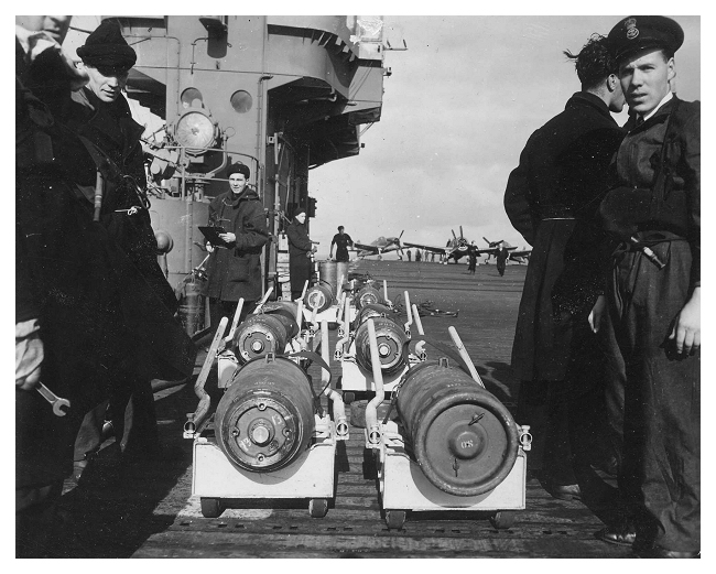 Armourers wait to load bombs onto the aircraft in preparation for an upcoming strike. Photo: Jack Price via Carl Berrington