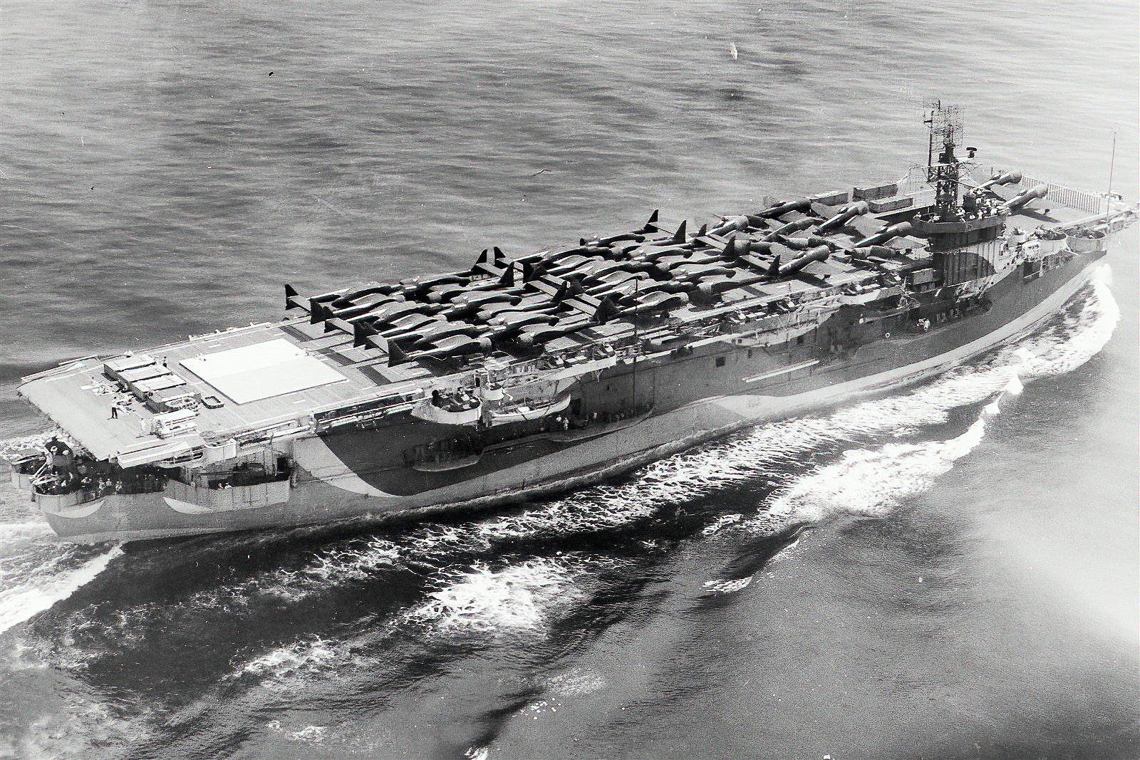 PUNCHER’s deck cargo included a number of the twin tail boomed P-61 ‘Black Widows’ of the 427th Night Fighter Squadron USAAF; a couple of P-47 Thunderbolts, can be seen towards the front of the flight deck .  .