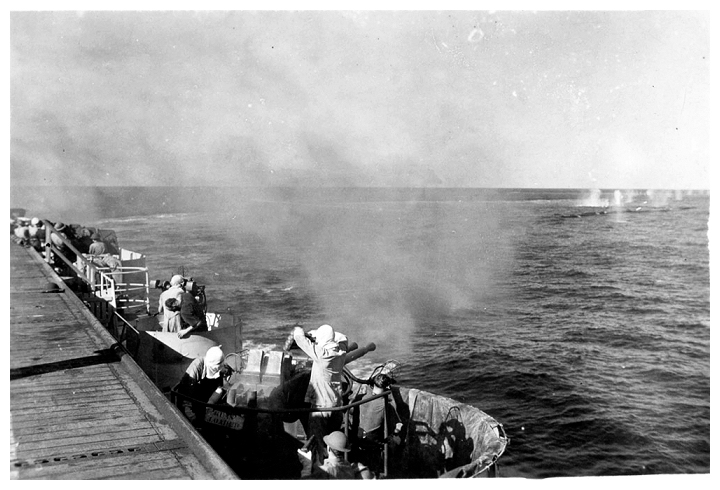 Starboard aft 40mm Bofors crew test fire their weapons during gunnery exercises in the Straits of Georgia, April 1944