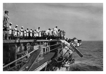 The burial at sea of Petty Officer Mitchell one of the casualties transferred from  HMS Indefatigable, he died on board Slinger on April 6th 1945 as the ship departed the refuelling area to return to Leyte.  Photo: Courtesy of David Yates