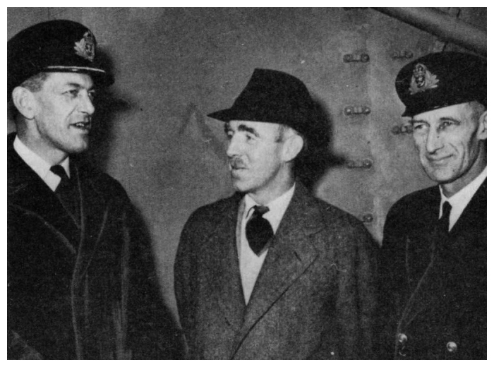 Taking over command of HMS Tracker, Commander G.C. Dickins RN poses with Mr. James McDonald, British Consul in Portland, and Lieutenant Commander S.K. Horn RN aboard Tracker.